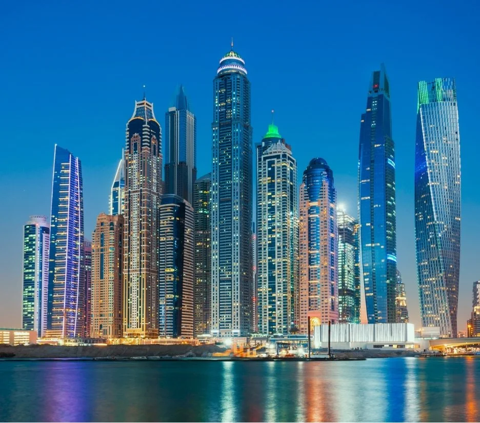 Dubai Marina skyline illuminated at night above the water, illustrating Dubai as an investment destination