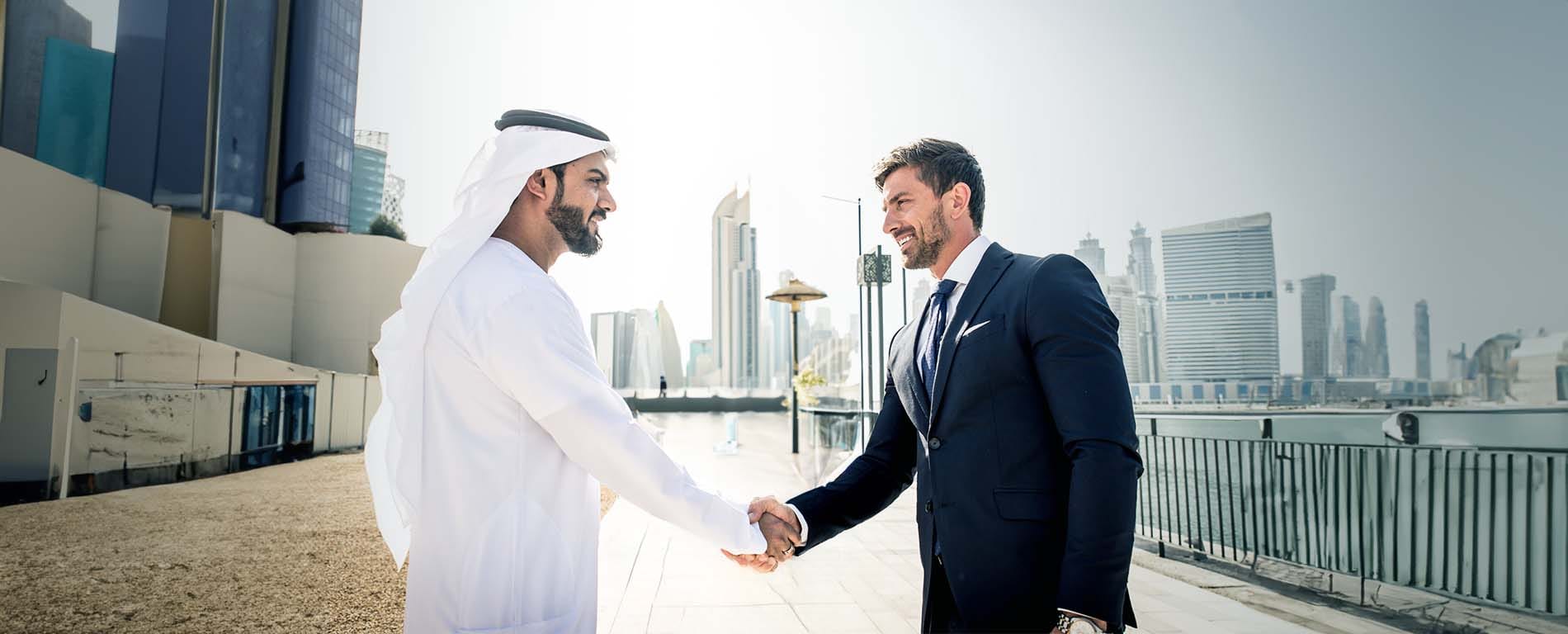 Arab and Western businessman shaking hands