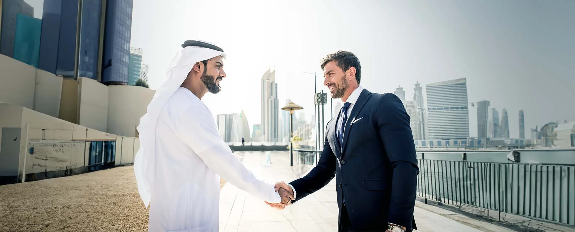 Arab and Western businessman shaking hands