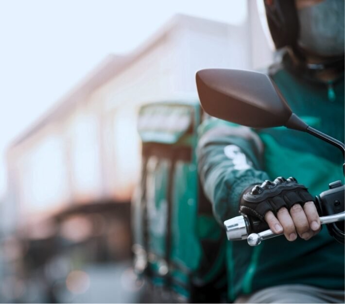 Delivery rider on a motorbike carrying an order, illustrating the rise of quick commerce in the UAE