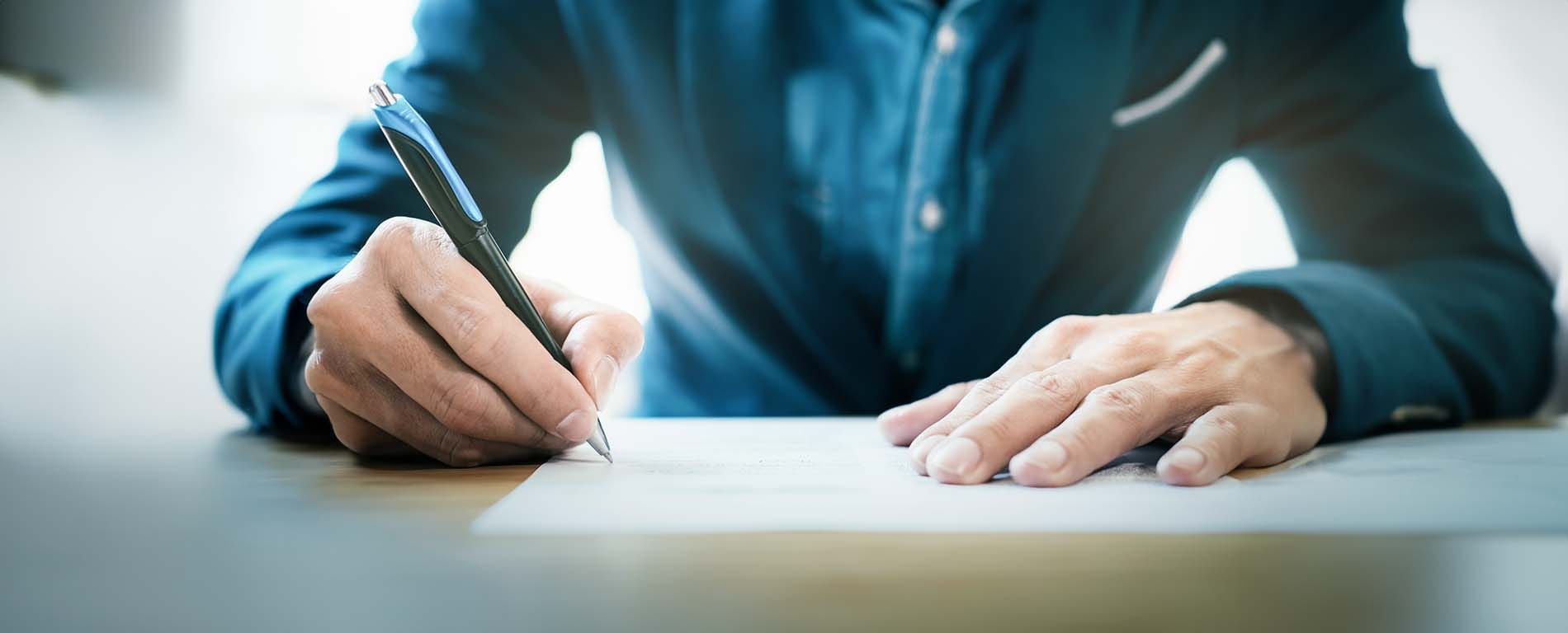 Man Signing Document