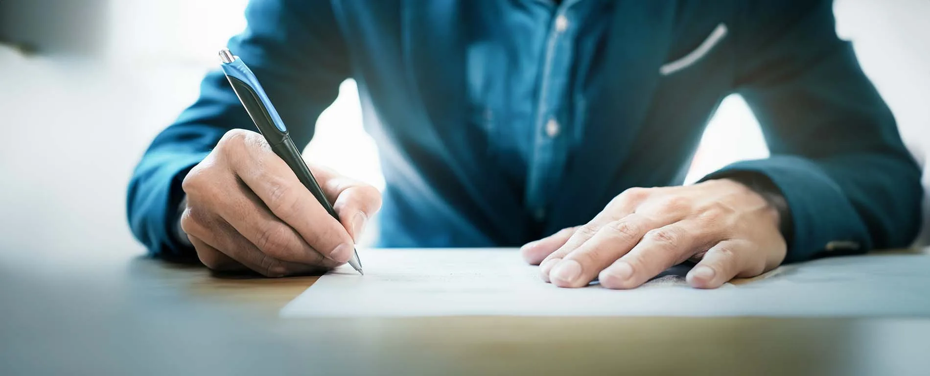 Man Signing Document