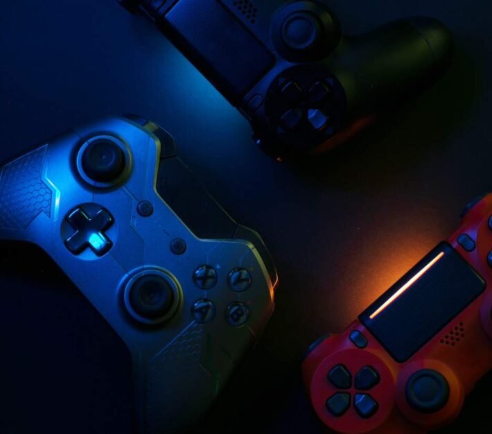 Games console controllers lit in blue and red, illustrating the Dubai gaming and esports industry